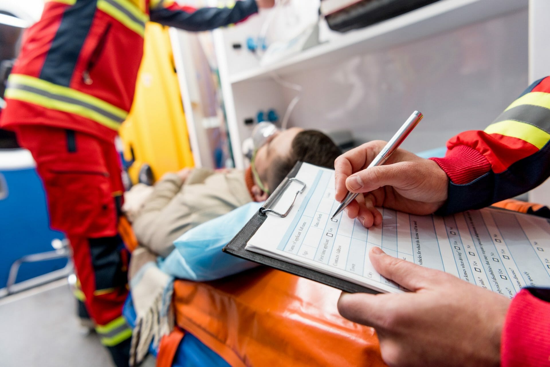 Medical team reviewing patient documents before ambulance transfer